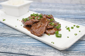 Mongolian beef on a white plate 