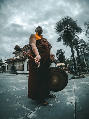 Monk Holding Bell