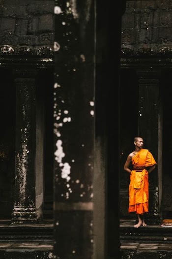 monk standing on a black temple