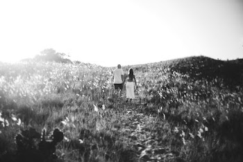 Monochrome Photo Of Couple Walking On A Grassfield