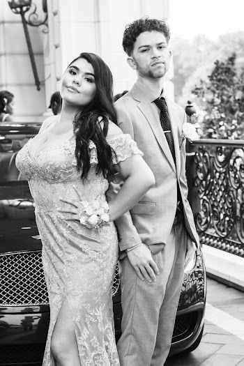 Monochrome Photo of Man and Woman Standing in Front of Vehicle
