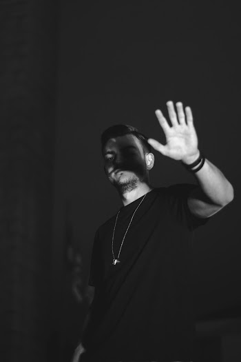 Monochrome Photo Of Man Raising His Hand
