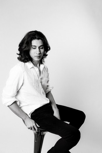 Monochrome Photo Of Man Sitting On Chair