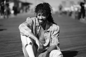 Monochrome Photo Of Man Sitting On The Ground