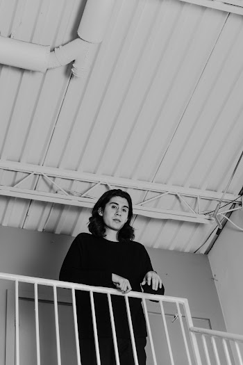 Monochrome Photo Of Man Standing Beside Hand Rail