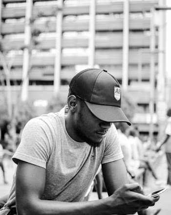 Monochrome Photo of Man Texting