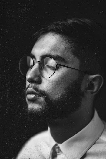 Monochrome Photo of Man Wearing Black Framed Eyeglasses