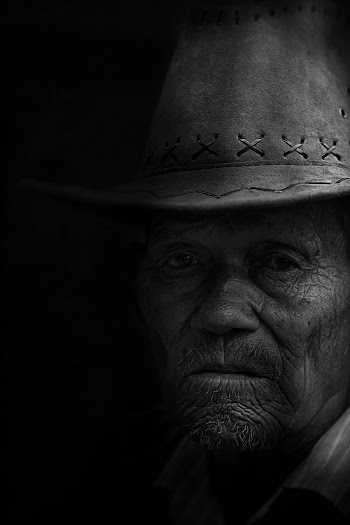 Monochrome Photo of Man Wearing Cowboy Hat