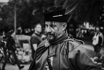 Monochrome Photo of Man Wearing Hat With Feather