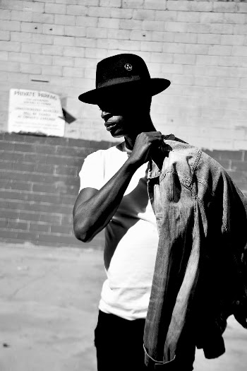 Monochrome Photo of Man Wearing White Shirt and Black Hat