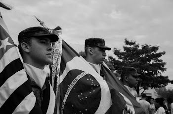 Monochrome Photo of Men Carrying Flags