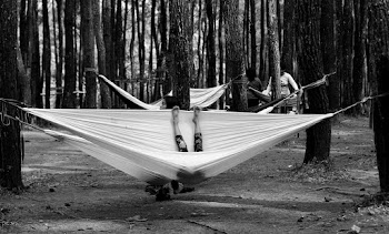 Monochrome Photo of People Inside Hammock