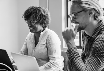 Monochrome Photo of People Using Laptop