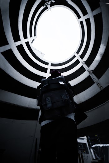 Monochrome Photo of Person Carrying Backpack