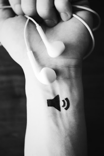 Monochrome Photo of Person Holding Earphones