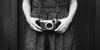 Monochrome Photo of Person Holding Vintage Camera