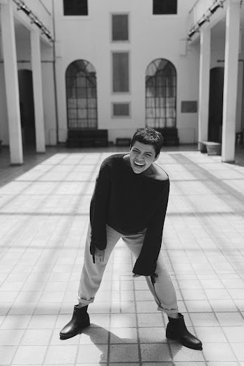 Monochrome Photo of Person Laughing While Standing on Pavement