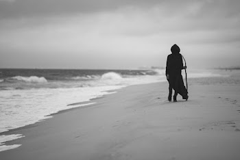 Monochrome Photo of Person Walking on Beach