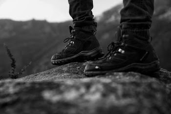 Monochrome Photo of Person Wearing Black Shoes