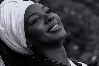 Monochrome Photo of Smiling Woman Wearing Headscarf