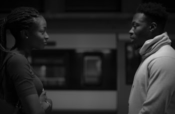 Monochrome Photo of Two Persons Looking at Each Other