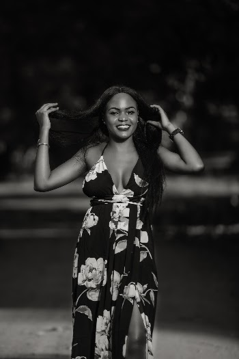 Monochrome Photo of Woman Holding Her Hair