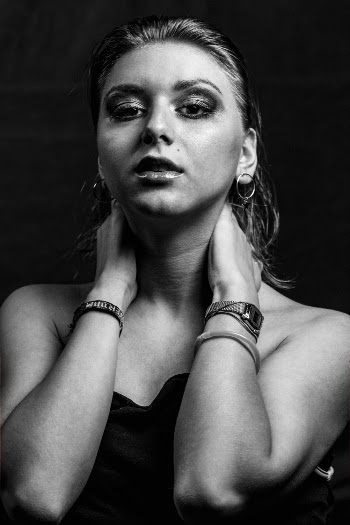 Monochrome Photo of Woman Holding Her Neck