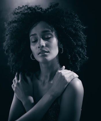 Monochrome Photo Of Woman Hugging Herself