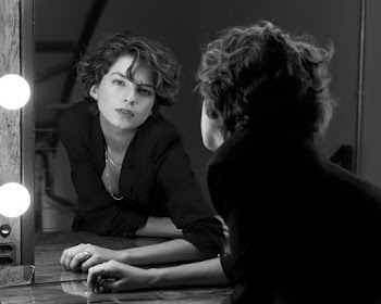 Monochrome Photo of Woman Leaning in Front of Vanity Mirror