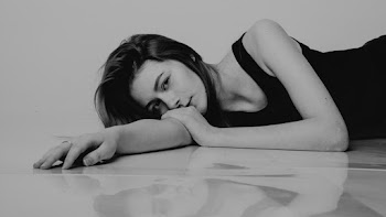 Monochrome Photo of Woman Lying Down on the Floor
