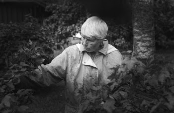 Monochrome Photo of Woman Near Plants