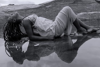 Monochrome Photo of Woman Posing Near Water