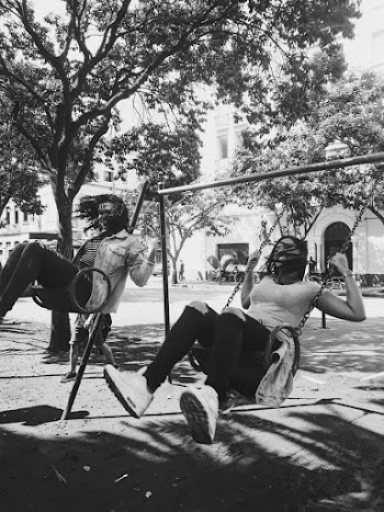 Monochrome Photo Of Woman Riding Swings