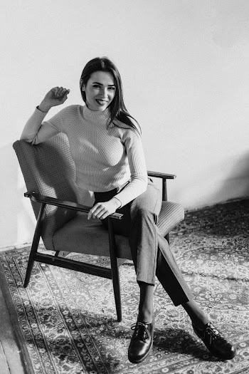 Monochrome Photo Of Woman Sitting On Chair