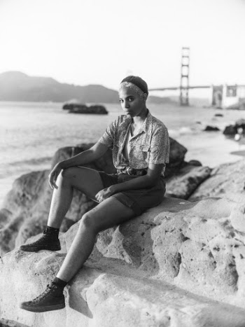 Monochrome Photo Of Woman Sitting On Rock