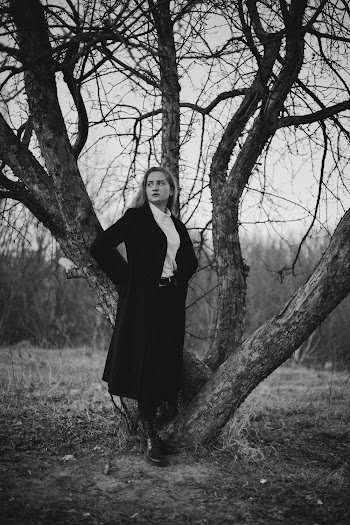 Monochrome Photo Of Woman Standing Beside Tree
