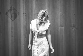 Monochrome Photo of Woman Standing Near Wall