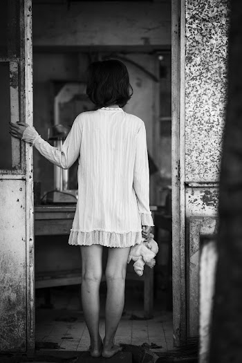 Monochrome Photo Of Woman Standing On Doorway