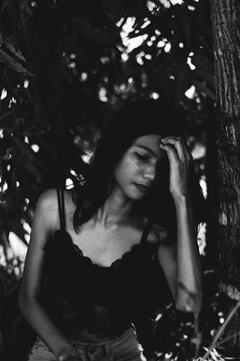 Monochrome Photo Of Woman Touching Her Head