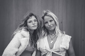 Monochrome Photo of Women Standing Near Wall