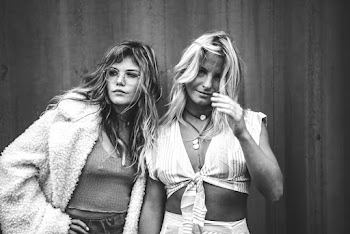 Monochrome Photo of Women Standing Near Wall