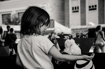 Monochrome Photography of Girl Playing With Bubbles