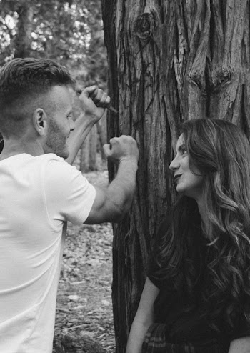Monochrome Photography of Man and Woman Near Tree