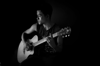 Monochrome Photography of Man Playing Guitar