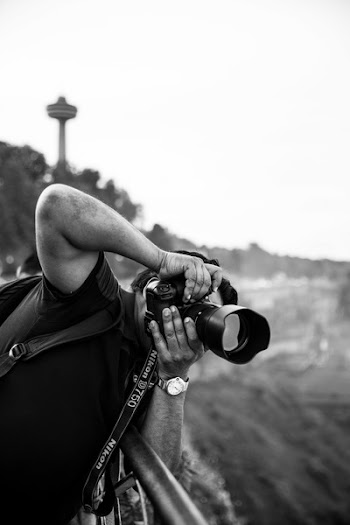 Monochrome Photography of Man Taking Picture
