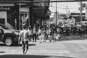 Monochrome Photography of People Crossing The Road