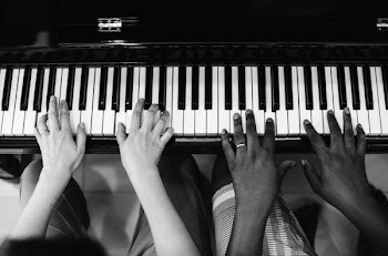 Monochrome Photography of People Playing Piano