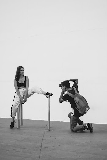 Monochrome Photography of Person Taking Photo of a Woman