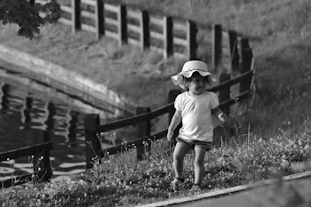 Monochrome Photography of Toddler On Flowers