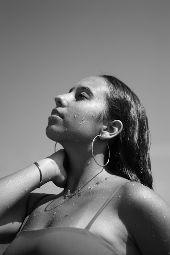 Monochrome Photography of Woman Holding Her Neck